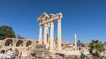 A Greek temple ruin consisting of five columns holding up a triangular-shaped crowning piece