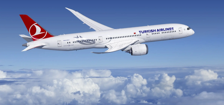 An airplane with the Turkish Airlines name and logo, flying above clouds