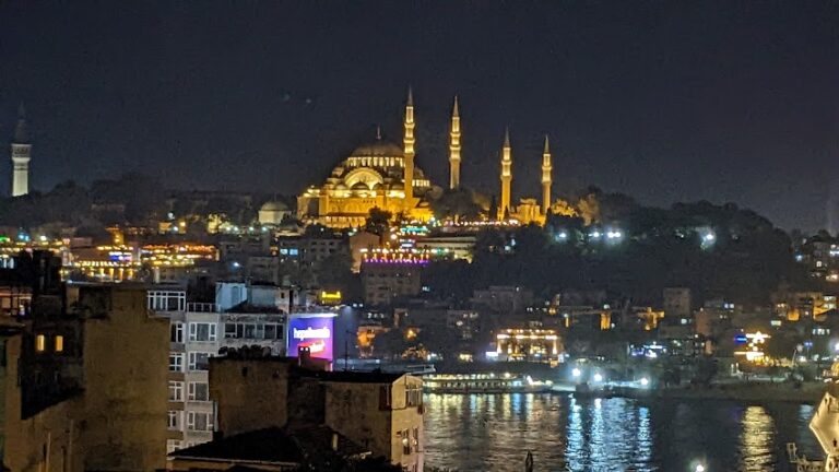A nighttime view of a mosque lit up